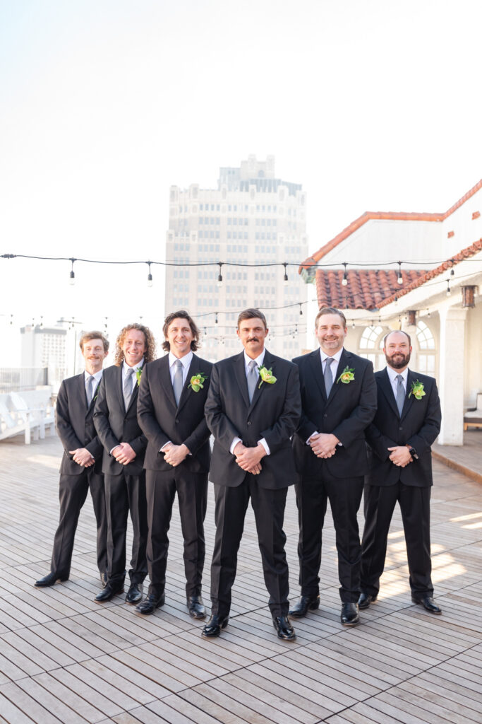 Groom and groomsmen on Sky Terrace rooftop at St. Anthony Hotel