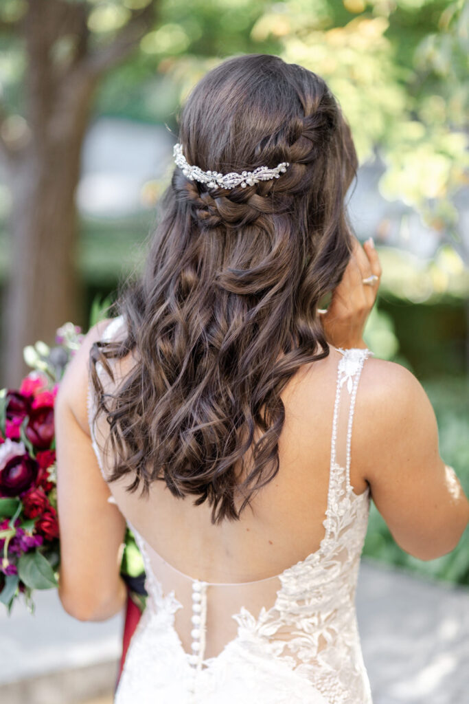Bridal hair with braid and rhinestone and pearl hairpiece