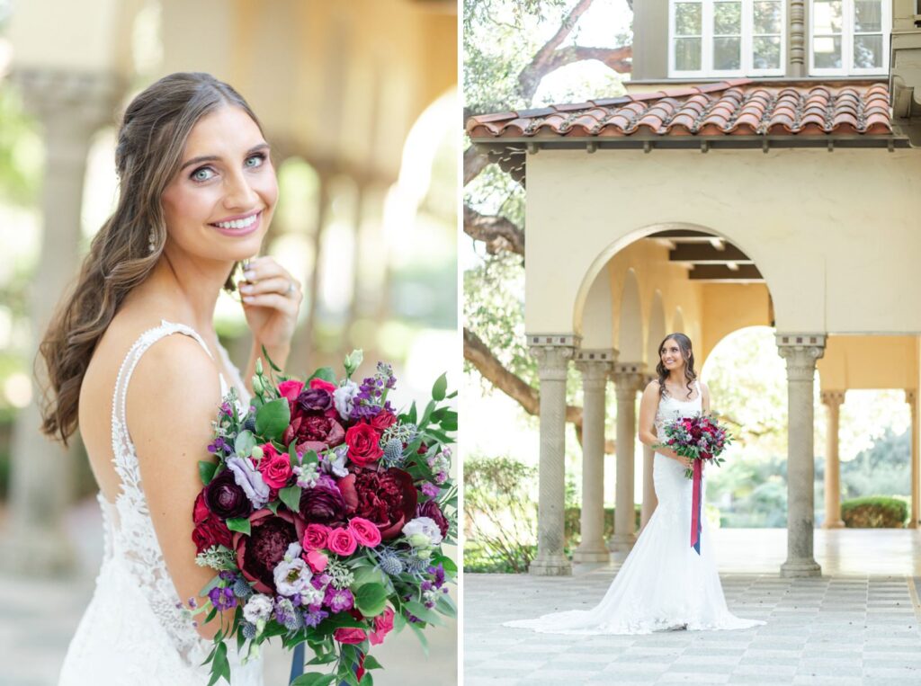Bride smiling in front of pillars at Landa Library holding a fall red and purple bouquet