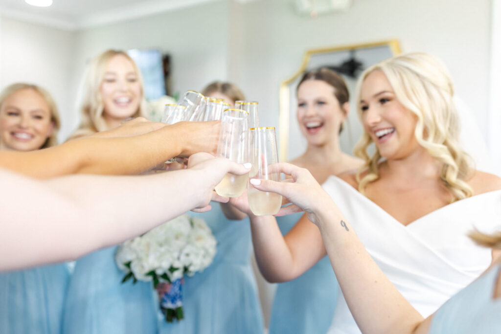 Bride and bridesmaids toasting champagne
