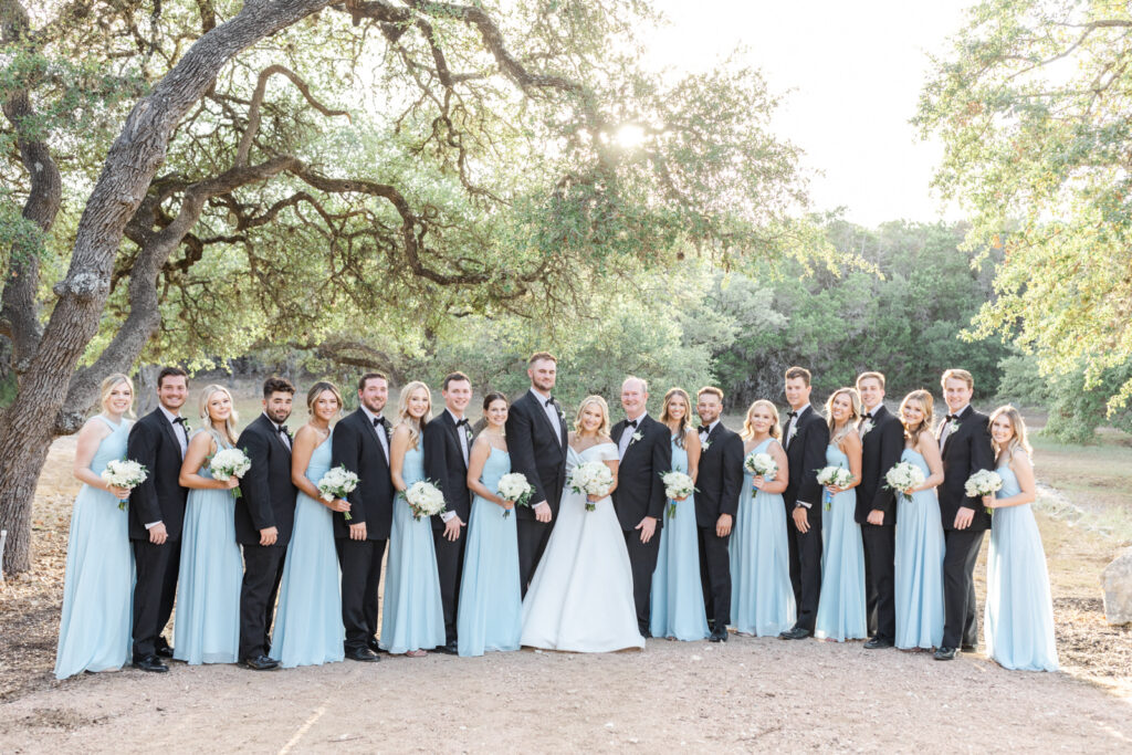 wedding party dressed in black tuxes and sky blue bridesmaid dresses