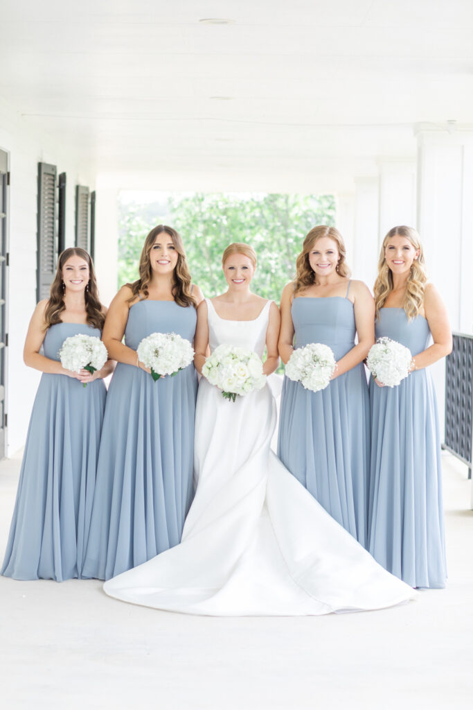 bridal party in dusty blue bridesmaids dresses