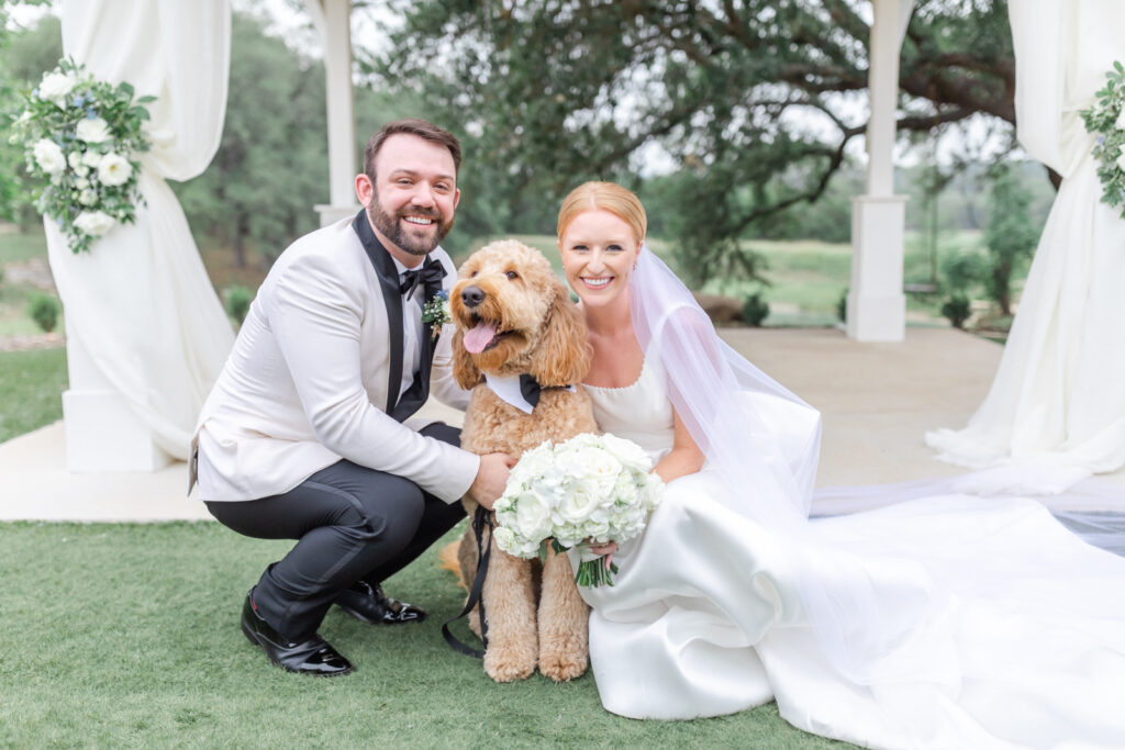 bride and groom with goldendoodle