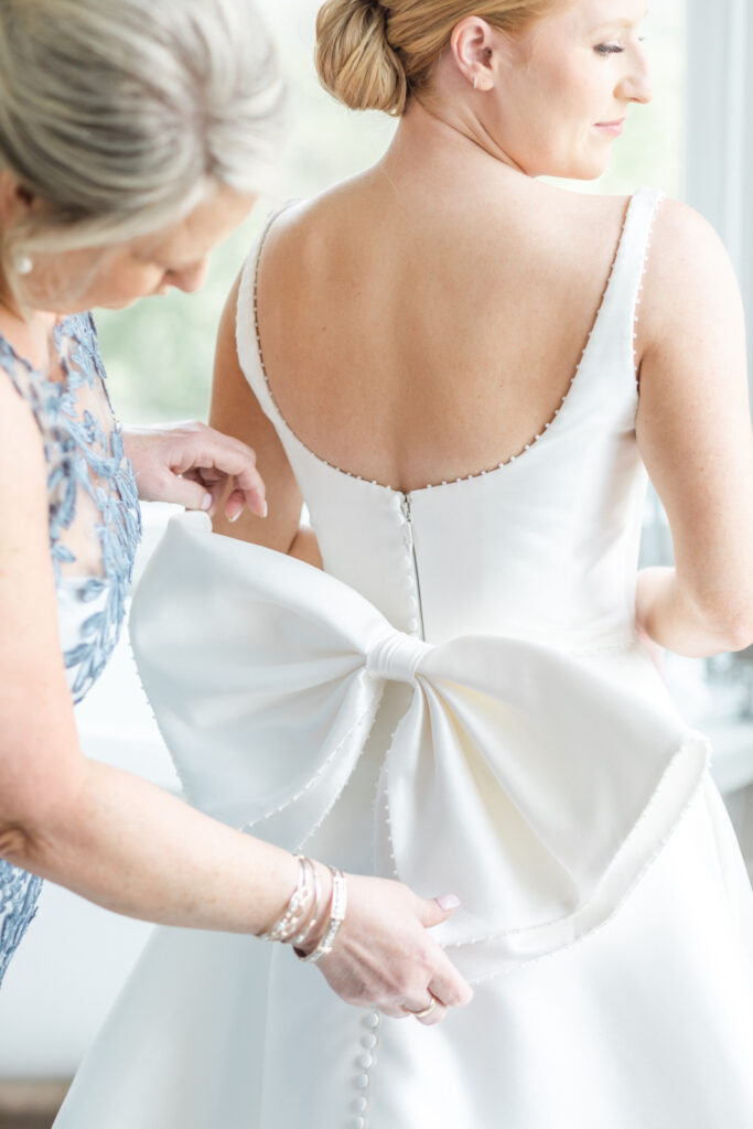 big bow on the back of satin wedding gown