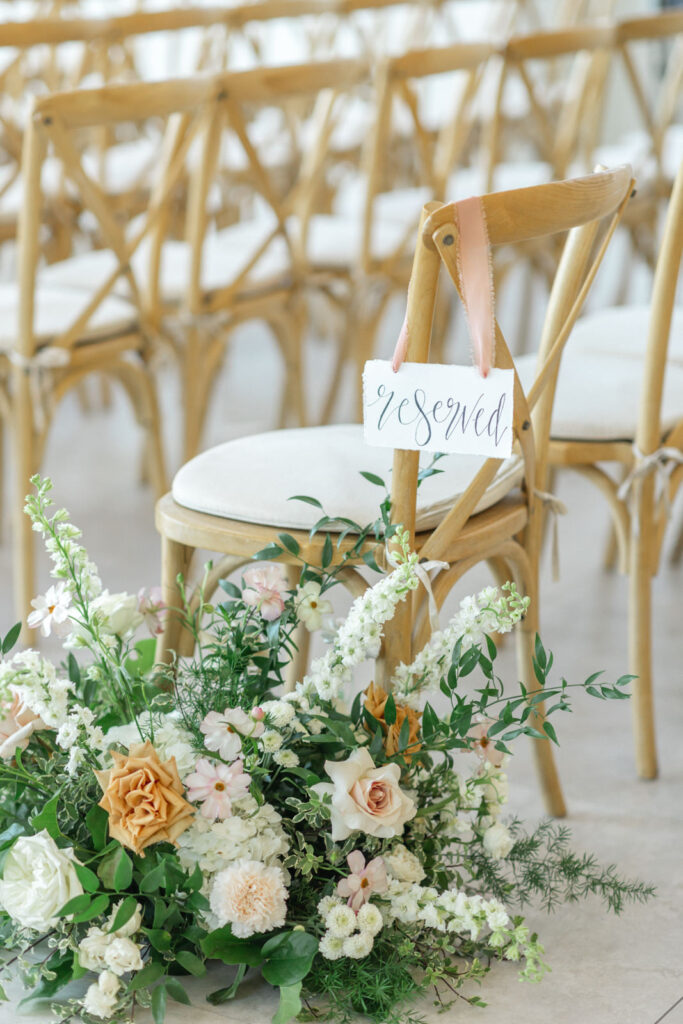 Fall wedding ceremony flowers and reserved sign 