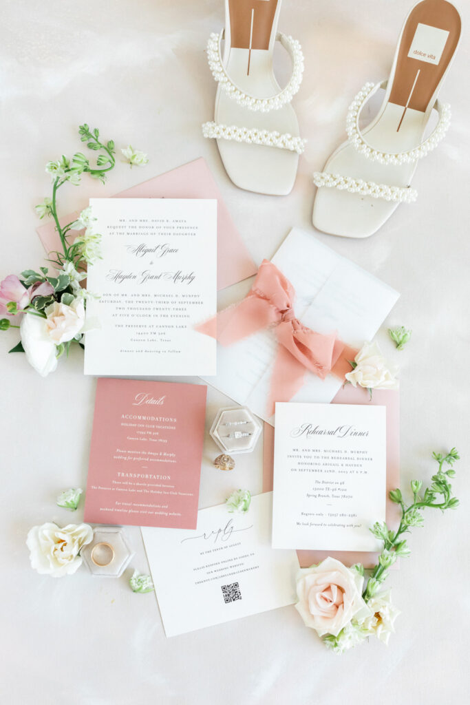 Custom wedding invitation suite with pink ribbon