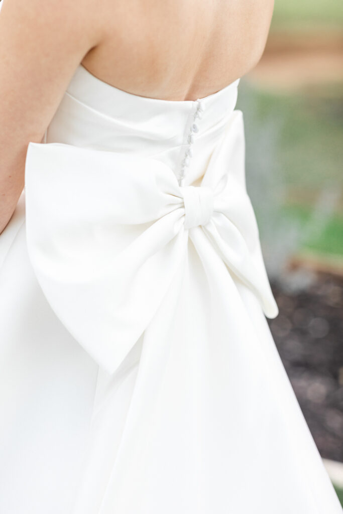 Big bow on the back of satin wedding gown