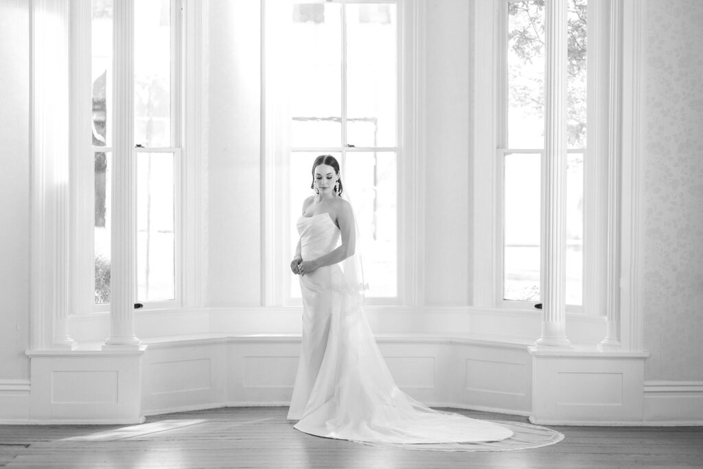 Bride in front of the windows inside the Allan House 