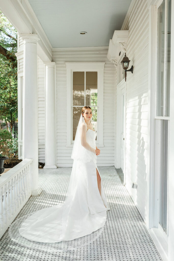 Bride on porch of the Allan House 