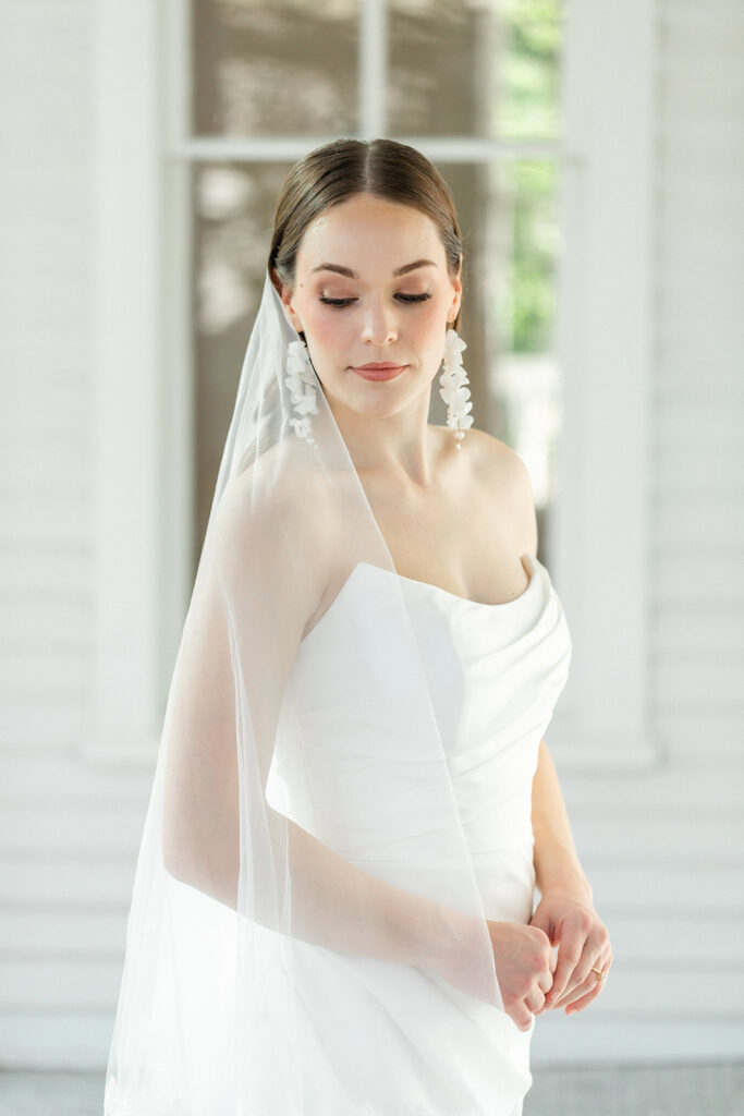 Bride looking down her shoulder with veil over her shoulder