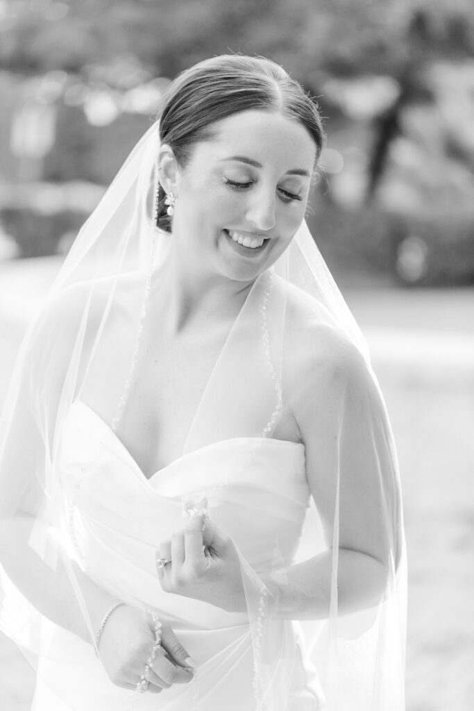 bride smiling down at veil