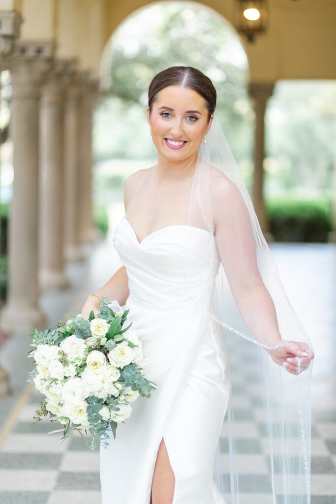 bride smiling while fluffing her veil